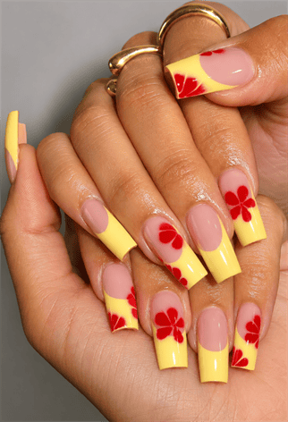 Pastel yellow French tip coffin nails with red hibiscus flower nail art, glossy nude base and tropical summer manicure design