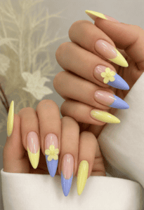 Pastel yellow and lavender French tip almond nails with 3D daisy flowers, glossy nude base and spring floral nail design