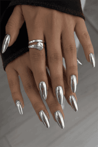 Mirror silver chrome almond nails with ultra-reflective metallic finish, glossy liquid chrome manicure and minimalist luxury nail design