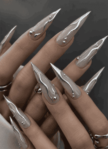 Silver chrome flame stiletto nails with mirror metallic finish, sculpted liquid chrome nail art and futuristic luxury manicure