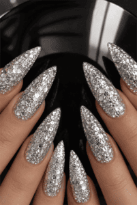 Silver glitter stiletto nails with chunky holographic glitter, ultra-sparkly full coverage and glamorous luxury manicure