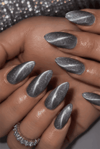Glossy silver cat eye almond nails featuring magnetic metallic shimmer and a luxurious velvet effect manicure