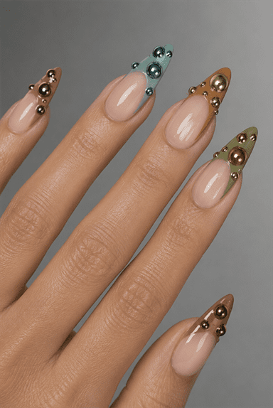 3D metallic bubble French tip almond nails with chrome sphere embellishments, glossy nude base and futuristic luxury nail design