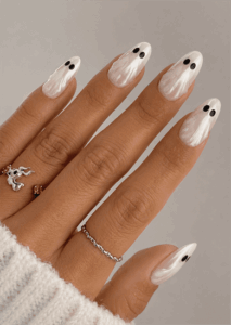 Cute ghost French tip almond nails with pearlescent white nail art, glossy finish and minimalist Halloween manicure