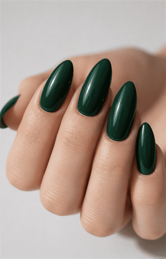 Glossy hunter green almond nails with solid dark green polish, elegant monochrome manicure and timeless minimalist nail design