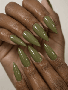 Glossy olive green stiletto nails with solid earthy polish, minimalist monochrome manicure and elegant fall nail design