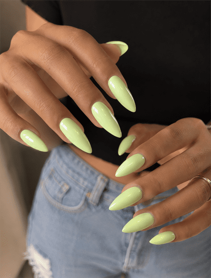 Pastel lime green almond nails with glossy solid-color finish, minimalist spring manicure and fresh monochrome nail design