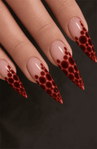 Red bubble French tip stiletto nails with glossy 3D droplet effect, nude base and bold abstract nail design