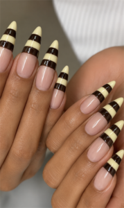 Chocolate brown and cream striped French tip almond nails with glossy nude base, minimalist dessert-inspired nail design and elegant neutral manicure