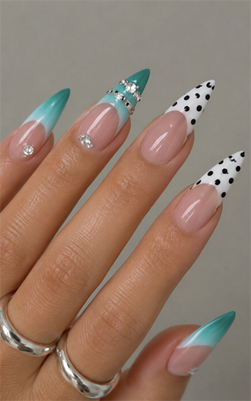 Teal ombré and black polka dot French tip stiletto nails with rhinestone accents, glossy nude base and modern statement manicure