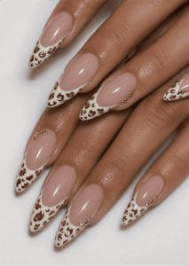 White French tip stiletto nails with gold leopard print accents, nude base and elegant animal print manicure