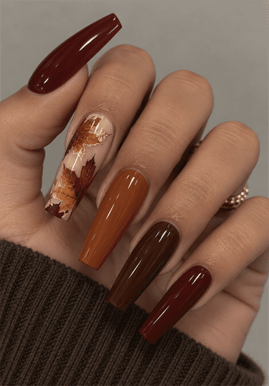 Autumn leaf coffin nails with burgundy, burnt orange and chocolate brown polish, maple leaf accent art and glossy fall finish