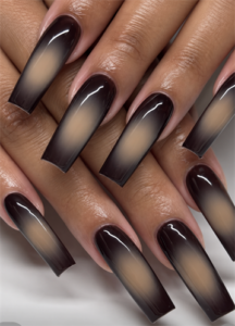 Extra-long coffin nails with glossy black smoky aura edges fading into soft nude centers