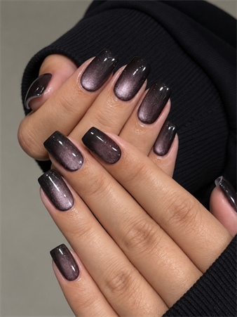Medium square black cat eye nails with smoky mauve magnetic shimmer and a glossy velvet finish