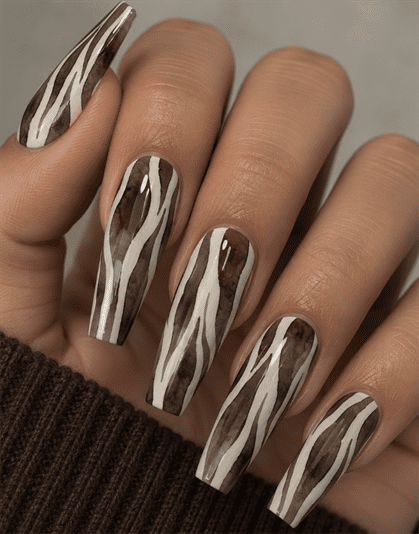 Brown and white zebra print coffin nails with abstract animal stripes and a glossy finish