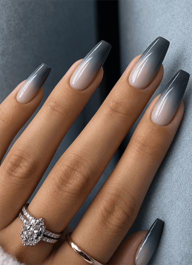 Gray ombré coffin nails fading from nude to charcoal tips with a glossy finish
