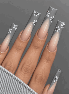 Gray ombré coffin nails with nude bases, white floral nail art and silver rhinestone accents