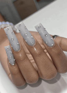 Gray coffin nails with scattered silver rhinestone embellishments and a glossy finish