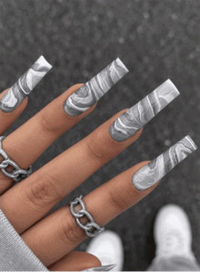 Gray and white marble coffin nails with smoky swirl patterns and a glossy finish