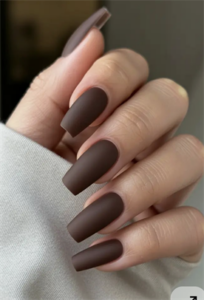 Long coffin nails with solid chocolate brown polish and a smooth matte finish