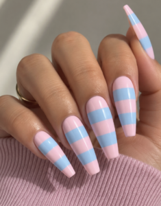 Pink and blue striped coffin nails with pastel color blocking and a glossy finish