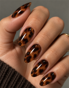 Medium almond nails with glossy amber, caramel brown and black tortoise shell nail art