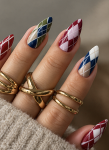 Long almond nails with multicoloured burgundy, navy, green and pink argyle diamonds and fine diagonal lines.