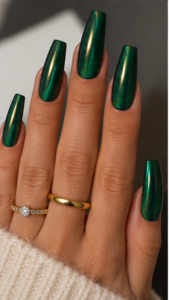Long coffin nails with deep emerald green chrome polish and reflective green-gold metallic shimmer. Essie – Off Tropic (alternative green) OPI – Black Onyx (optional darker base) Emerald green chrome powder or green metallic gel