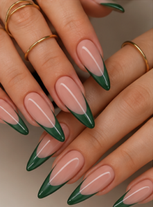 Long almond nails with sheer nude-pink bases and glossy emerald green V-shaped French tips.