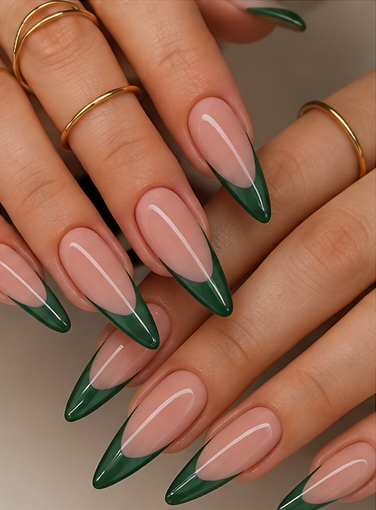 Long almond nails with sheer nude-pink bases and glossy emerald green V-shaped French tips.