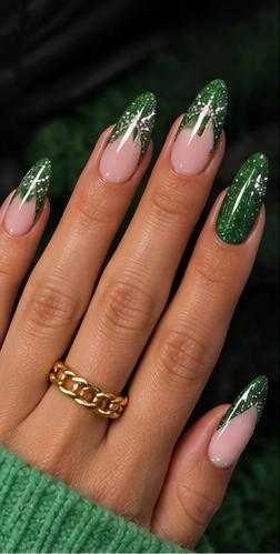 Almond nails with sheer pink bases, emerald green glitter French tips and sparkling green accent nails.
