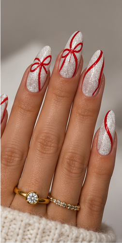 Almond nails with sparkling silver glitter polish and delicate red ribbon and bow nail art.